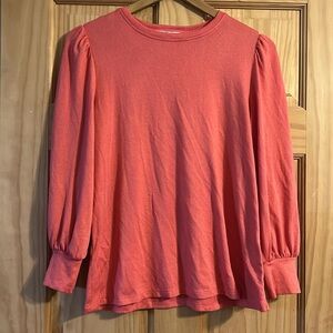 Orange / Coral colored top.